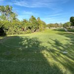 Panoramic view of a lush green golf course at Timber Creek Golf Course. Smooth