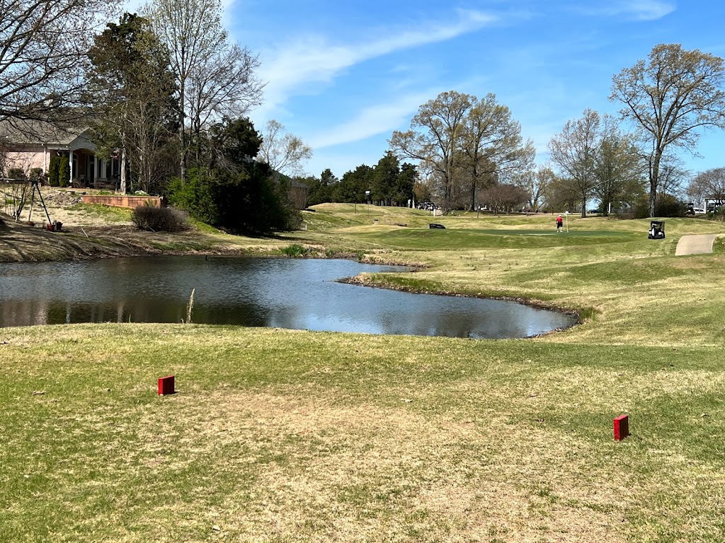 Panoramic view of a lush green golf course at Timber Truss Golf Course. Smooth