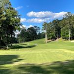 Panoramic view of a lush green golf course at Timberline Golf Club. Smooth