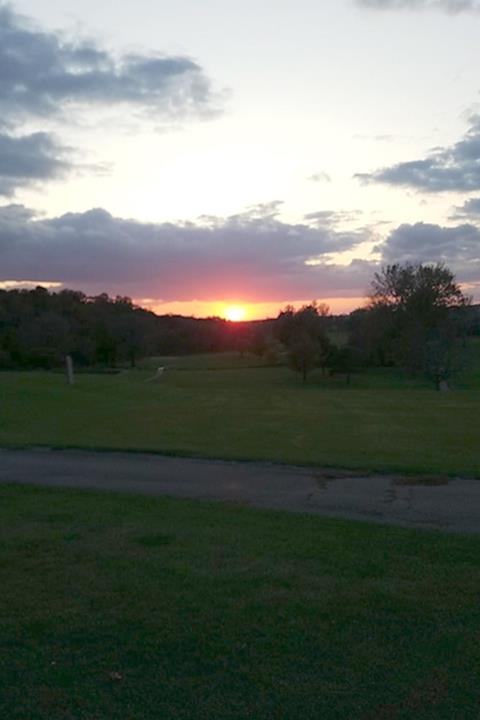 Panoramic view of a lush green golf course at Timberline Golf Course. Smooth