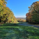 Panoramic view of a lush green golf course at Toddy Brook Golf Course. Smooth