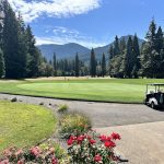 Panoramic view of a lush green golf course at Tokatee Golf Club. Smooth