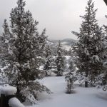 Panoramic view of a lush green golf course at Tom Weiskopf Signature Golf Course at The Club at Spanish Peaks. Smooth