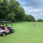 Panoramic view of a lush green golf course at Tomahawk Hills Golf Course. Smooth