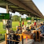 Panoramic view of a lush green golf course at TopCITYGolf at GreatLIFE North. Smooth