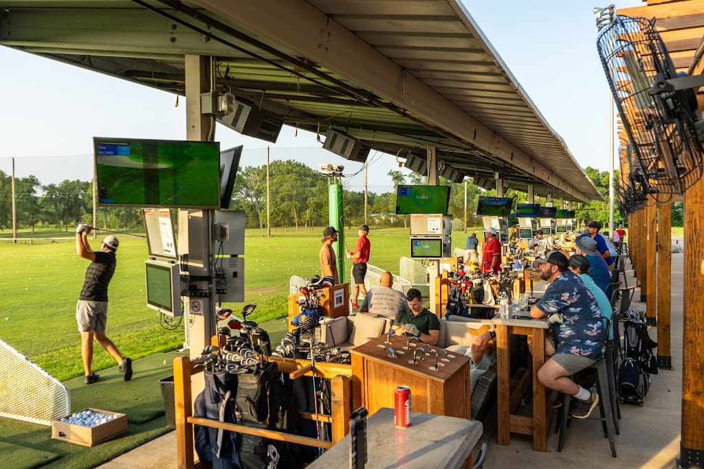 Panoramic view of a lush green golf course at TopCITYGolf at GreatLIFE North. Smooth