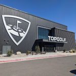 Panoramic view of a lush green golf course at Topgolf Albuquerque. Smooth