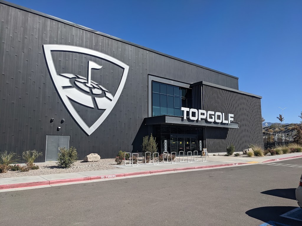 Panoramic view of a lush green golf course at Topgolf Albuquerque. Smooth