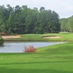 Panoramic view of a lush green golf course at Traces Golf Club & Shankers Grille. Smooth