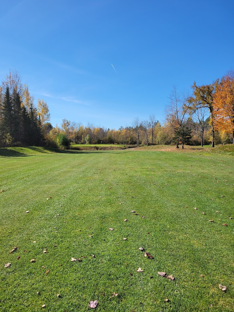 Panoramic view of a lush green golf course at Traditions Golf Club and Learning Center. Smooth