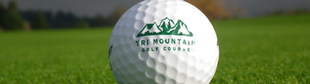 Panoramic view of a lush green golf course at Tri-Mountain Golf Course. Smooth