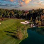 Panoramic view of a lush green golf course at Troubadour Golf & Field Club. Smooth