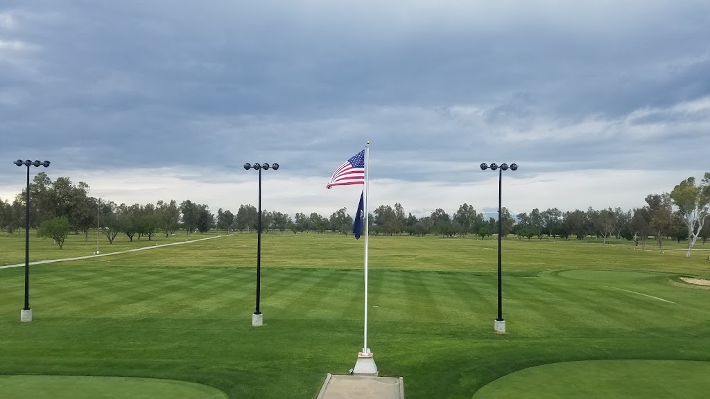 Panoramic view of a lush green golf course at Tulare Golf Course. Smooth