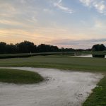 Panoramic view of a lush green golf course at Tupelo National Golf Course. Smooth