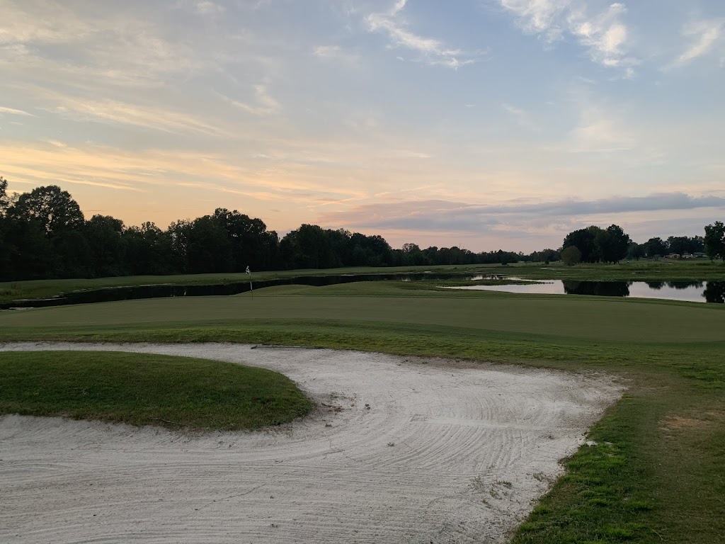 Panoramic view of a lush green golf course at Tupelo National Golf Course. Smooth