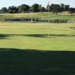 Panoramic view of a lush green golf course at Turkey Creek Golf Course. Smooth