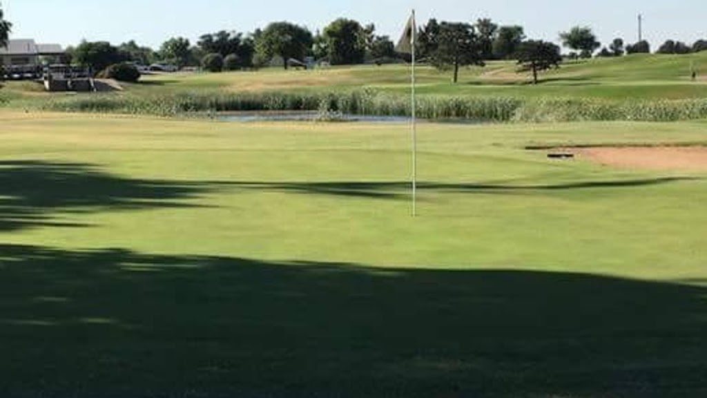 Panoramic view of a lush green golf course at Turkey Creek Golf Course. Smooth