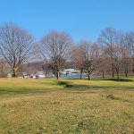 Panoramic view of a lush green golf course at Turkeyfoot Golf Course Maintenance. Smooth