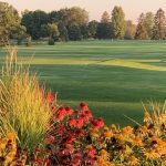 Panoramic view of a lush green golf course at Twin Pines Golf Course. Smooth