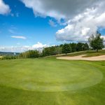 Panoramic view of a lush green golf course at Tyoga Golf Course. Smooth