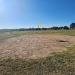 Panoramic view of a lush green golf course at University Park Golf Course. Smooth