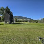 Panoramic view of a lush green golf course at University of Montana Golf Course. Smooth