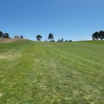 Panoramic view of a lush green golf course at University of New Mexico. Smooth