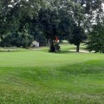 Panoramic view of a lush green golf course at Valley Country Club. Smooth