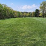 Panoramic view of a lush green golf course at Valley Green Golf Course. Smooth