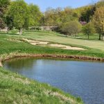 Panoramic view of a lush green golf course at Valley of the Eagles Golf Club. Smooth