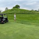 green grass with the flag in the hole.