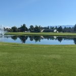 Panoramic view of a lush green golf course at Village Greens Golf Course. Smooth