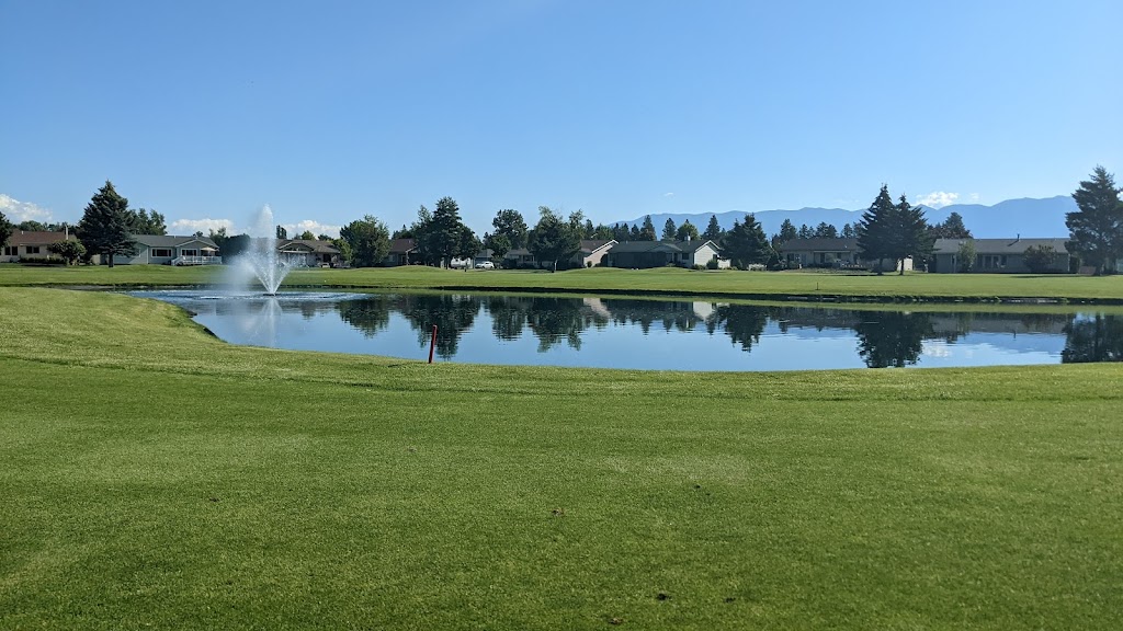 Panoramic view of a lush green golf course at Village Greens Golf Course. Smooth