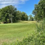 Panoramic view of a lush green golf course at Vintage Golf Course. Smooth