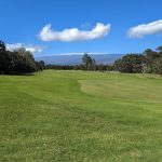 Panoramic view of a lush green golf course at Volcano Golf Course. Smooth