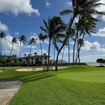 Panoramic view of a lush green golf course at Wai`alae Country Club. Smooth