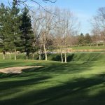 Panoramic view of a lush green golf course at Walnut Creek Golf Courses. Smooth