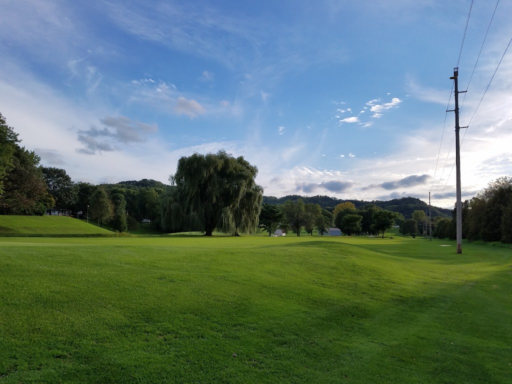 Panoramic view of a lush green golf course at Walsh Golf Center. Smooth