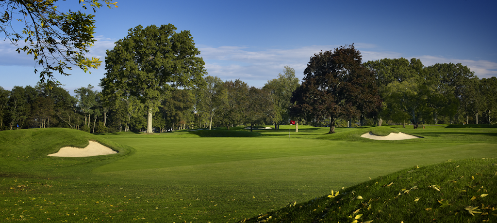 Panoramic view of a lush green golf course at Wannamoisett Country Club. Smooth