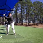 Panoramic view of a lush green golf course at Warrior Hills Golf Course. Smooth