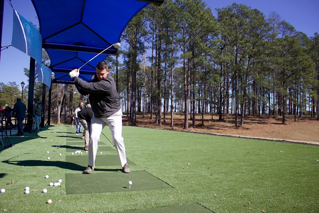 Panoramic view of a lush green golf course at Warrior Hills Golf Course. Smooth