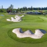 Panoramic view of a lush green golf course at Washington National Golf Club. Smooth