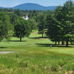 Panoramic view of a lush green golf course at Waubeeka Springs Golf Course. Smooth