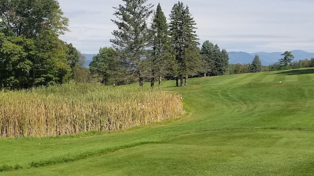 Panoramic view of a lush green golf course at Waukewan Golf Club. Smooth