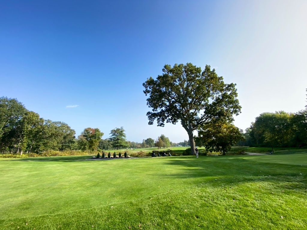 Panoramic view of a lush green golf course at Wayland Country Club. Smooth