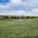 Panoramic view of a lush green golf course at Weekapaug Golf Course. Smooth