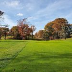 Panoramic view of a lush green golf course at Weequahic Golf Course. Smooth