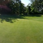 Panoramic view of a lush green golf course at Wenham Country Club. Smooth