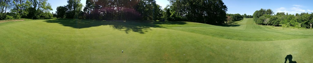 Panoramic view of a lush green golf course at Wenham Country Club. Smooth