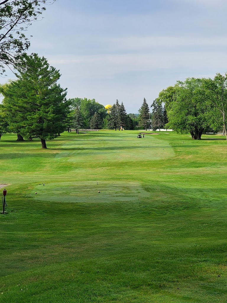 Panoramic view of a lush green golf course at West Branch Country Club. Smooth